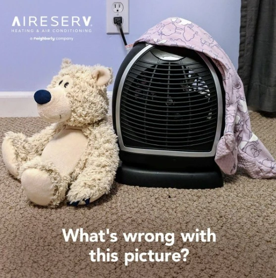 What's wrong with this picture text in front of space heater covered with blanket next to teddy bear