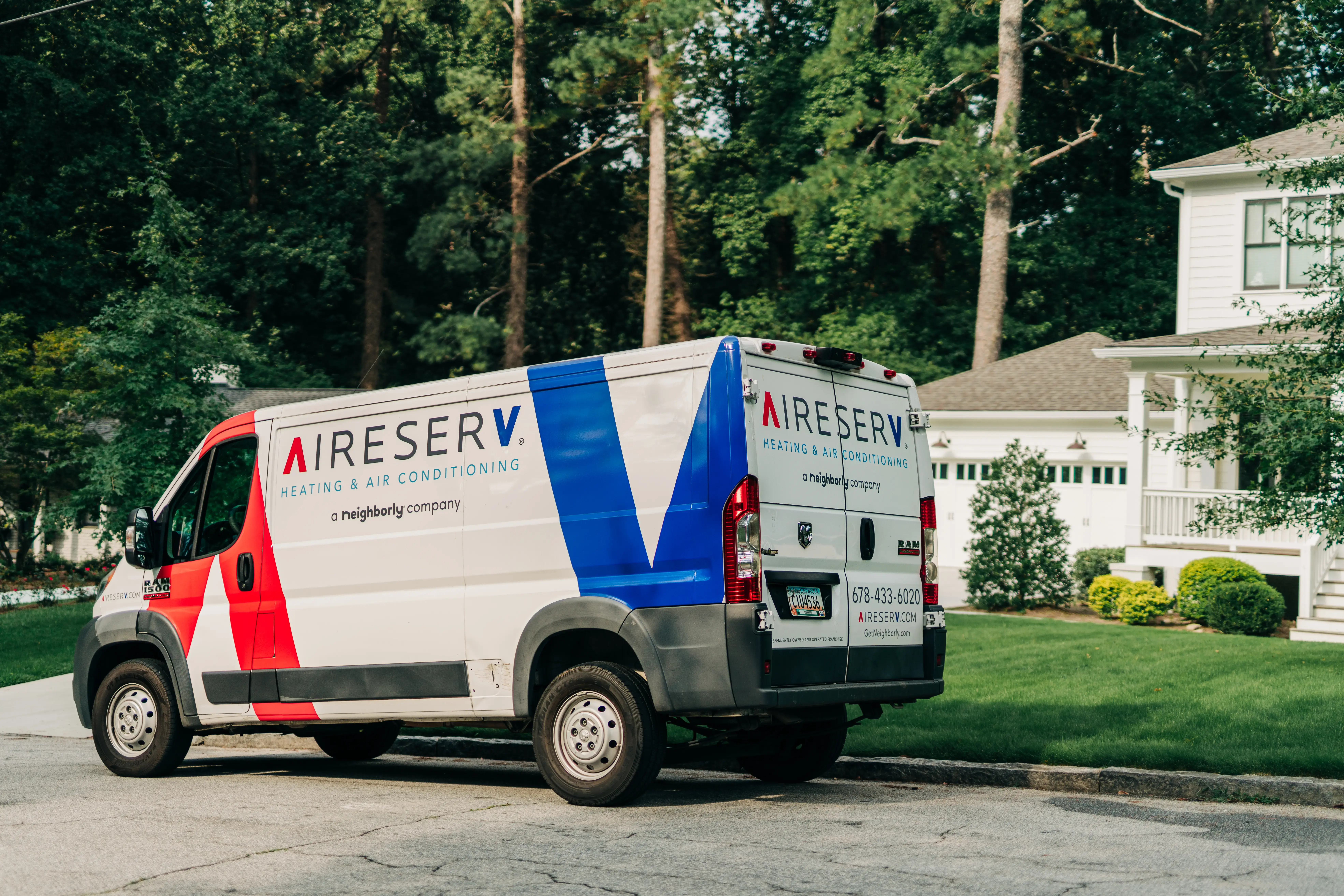 Aire Serv branded van parked in front of residential home.