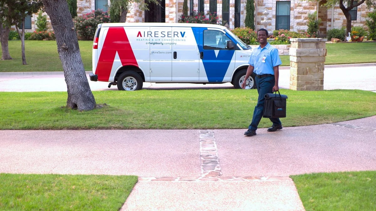 Aire Serv heating and cooling service professional arriving at Houston home to perform furnace repairs.