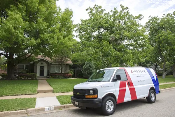A van from Aire Serv parked outside of a home in need of heating repair in McKinney, TX.