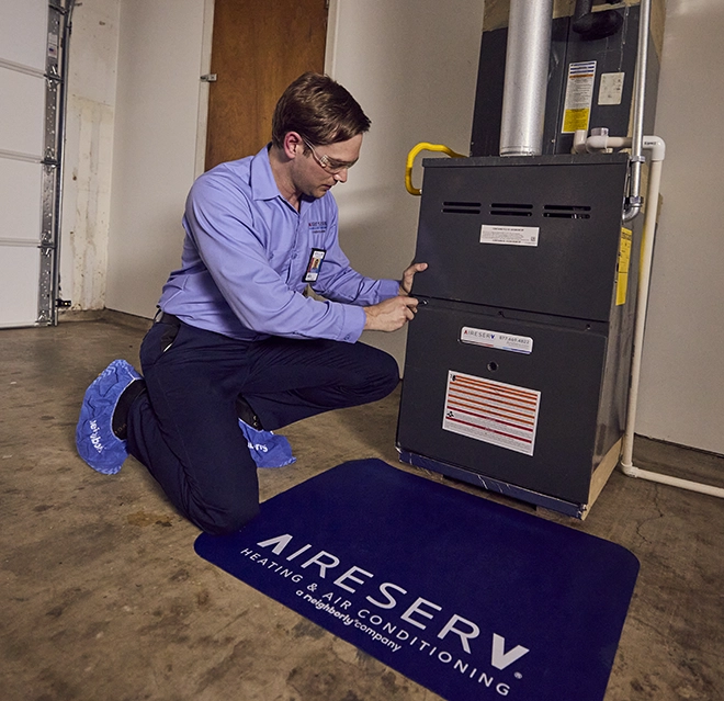 Aire Serv technician working on a customer's furnace.