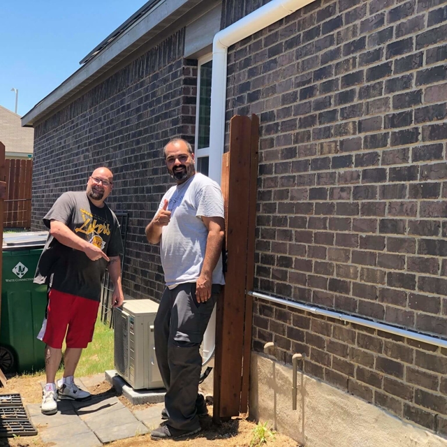 ASV technicians outside building with HVAC unit