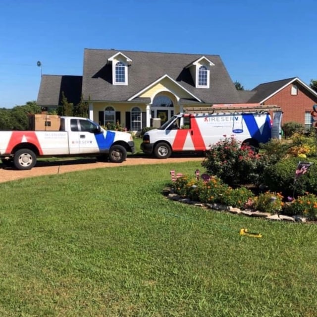 Aire Serv Vans outside of home