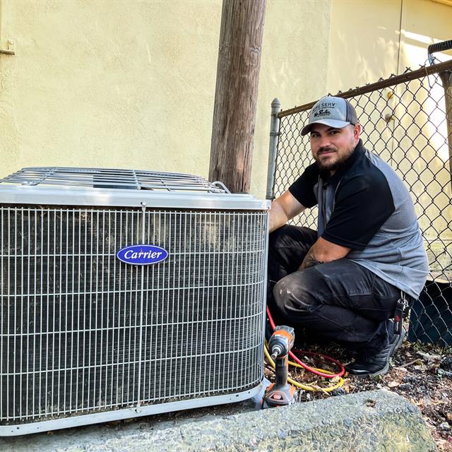 Aire Serv pro working on Carrier AC unit