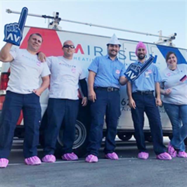 Aire Serv team in front of ASV van showing support for Breast Cancer Awareness Month.