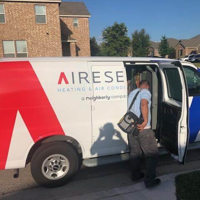 Aire Serv technician getting into Aire Serv van