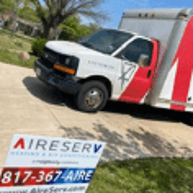 Aire Serv truck in front of Aire Serv sign