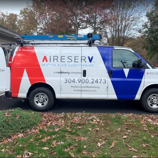 Aire Serv van with back door open parked in drive way.