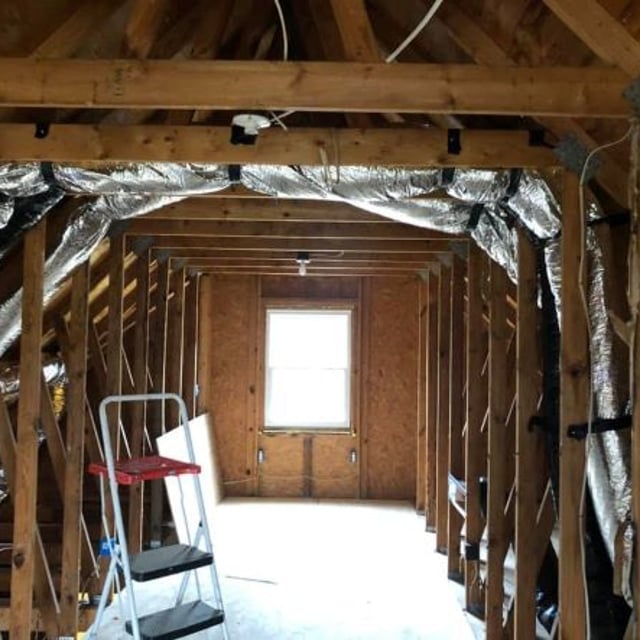 Attic duct work installation with ladder.