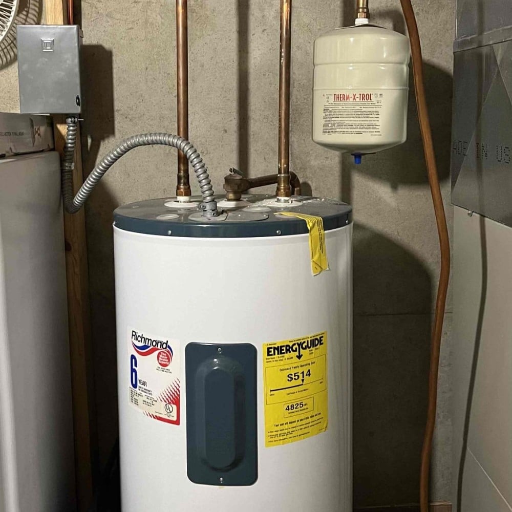 Round White Water Heater Installed in a Basement