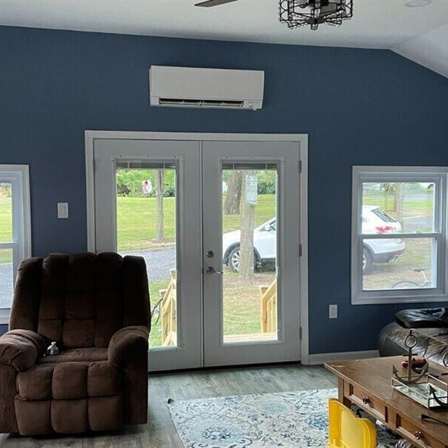 HVAC unit above double doors on a blue wall