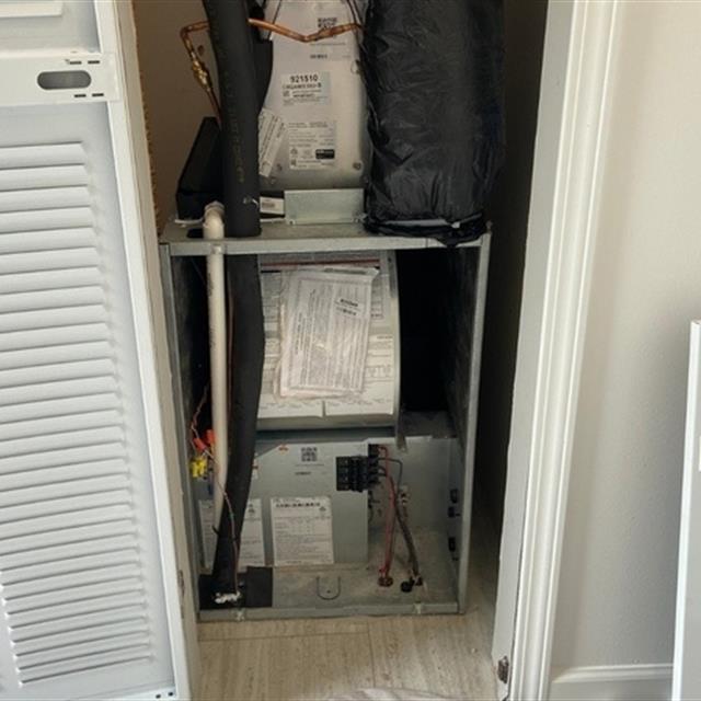 HVAC unit inside a closet with its front off