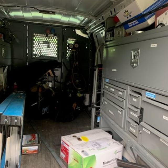 Inside the back of an Aire Serv van that has a tool chest