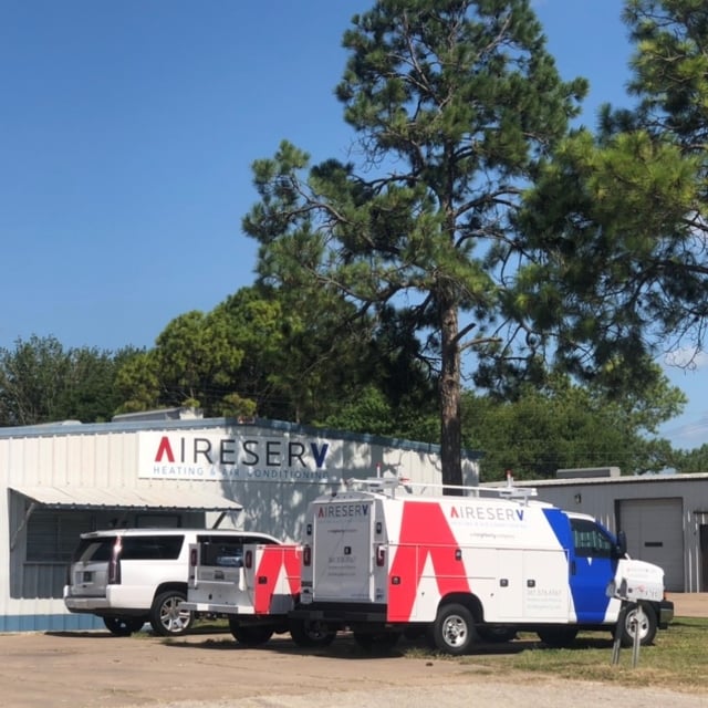 Outside of Aire Serv of Victoria office with work vans