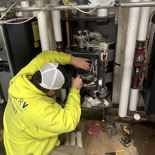 Employee working on repairing a boiler