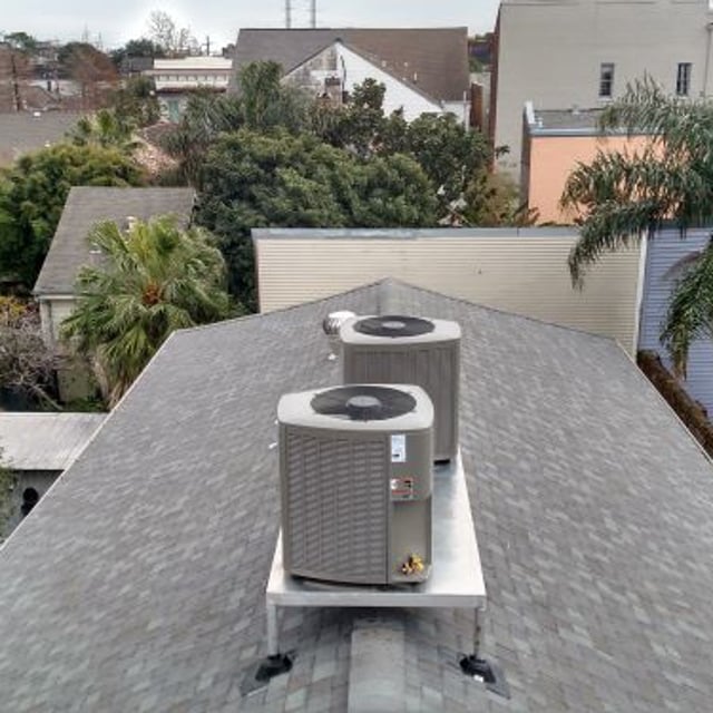 Two AC condensers on on grey roof