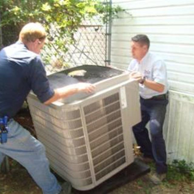 Two Aire Serv installing HVAC unit