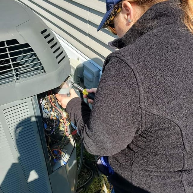 Aire Serv Employee Working on AC Unit