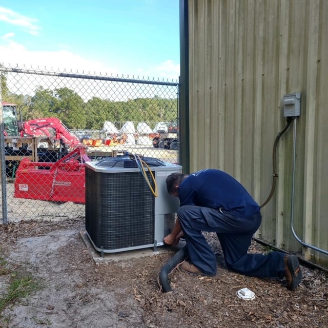 aire serv employee working on unit