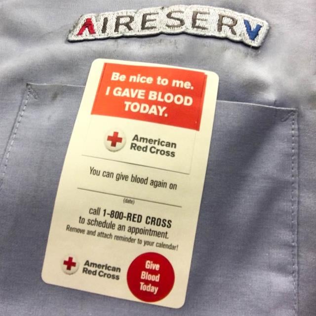 blood donation sticker on Aire Serv work shirt