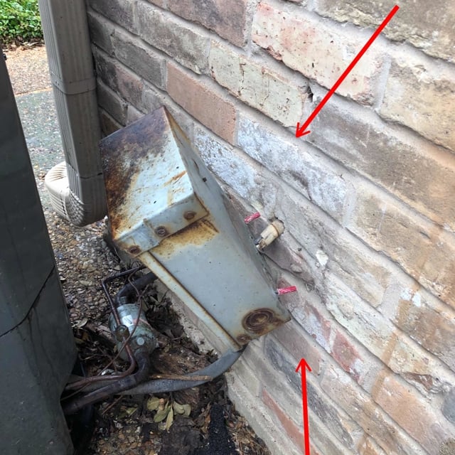 box falling off brick wall