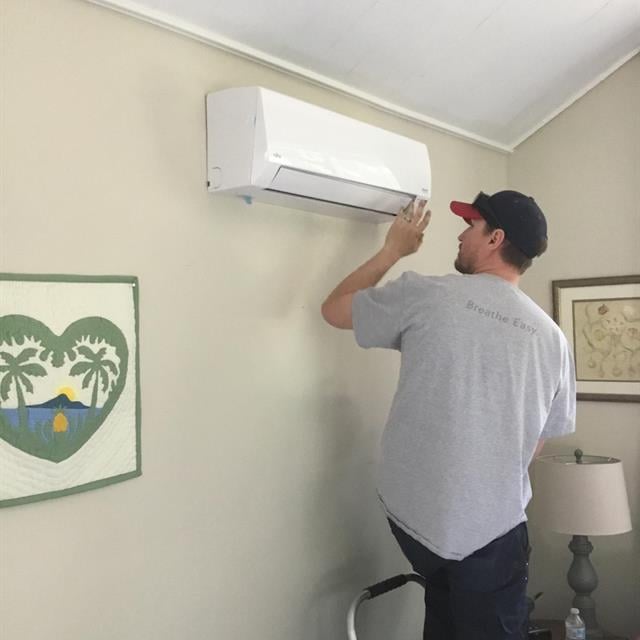 employee working on indoor ac unit