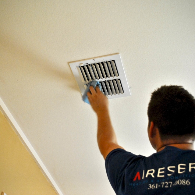 man cleaning air vent