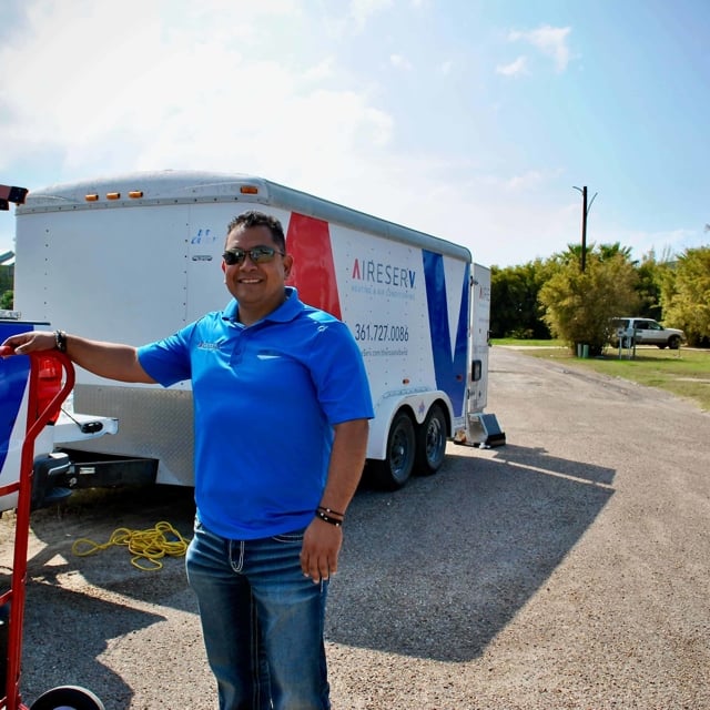 man in front of aire serv trailer