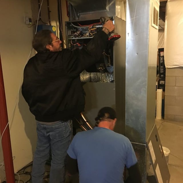 techs working on air handler