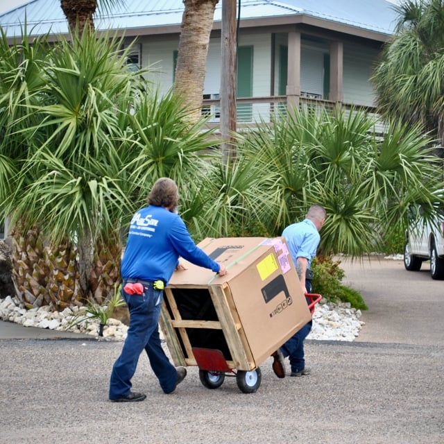 two men moving a box