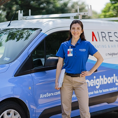 Aire Serv professional standing in front of a van.