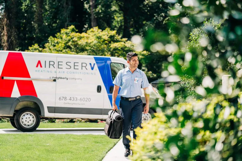 Aire Serv HVAC specialist driving his work van to an air duct replacement in Firestone, CO 