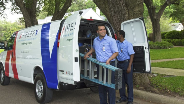 Aire Serv service professionals taking ladder and tools from truck to provide HVAC service for residential home