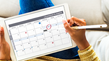 Person on tablet looking at calendar