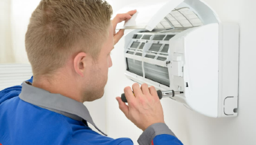 AC Technician fixing AC unit