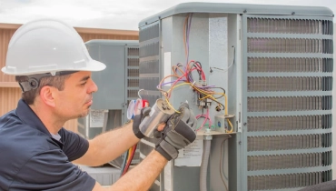 HVAC tech assessing HVAC unit