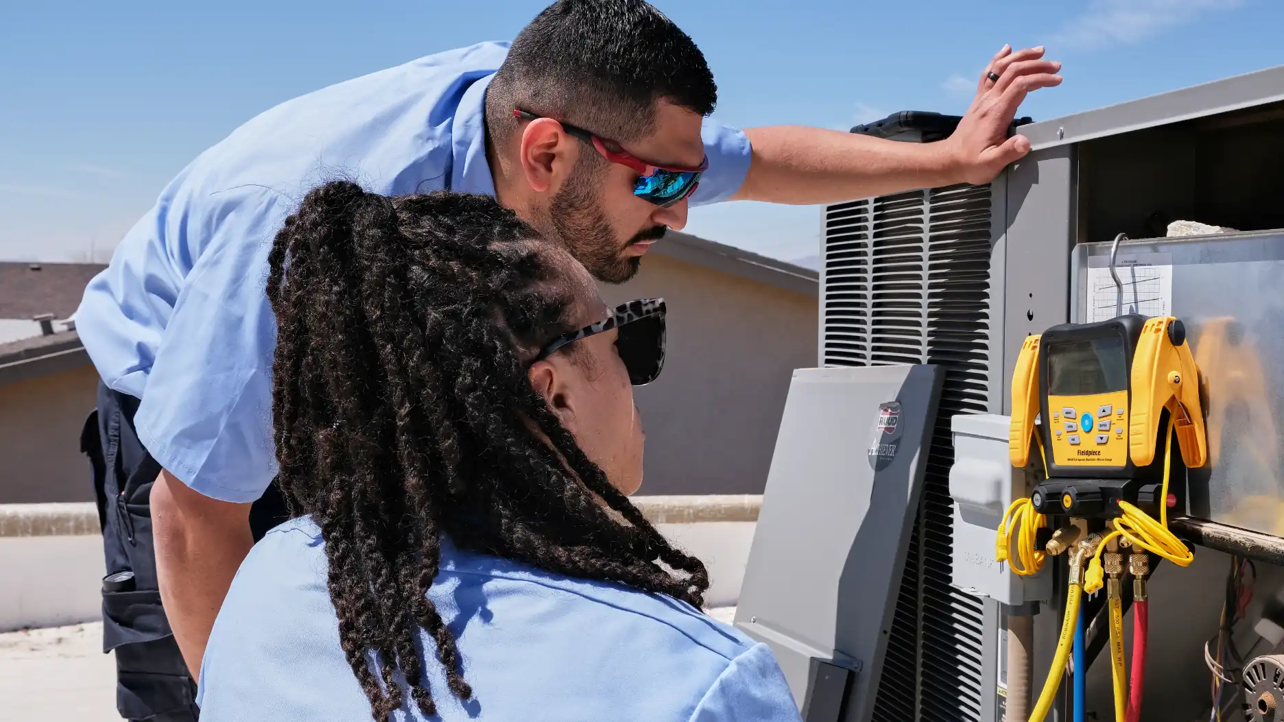 Aire Serv technician performing air conditioner repair service.