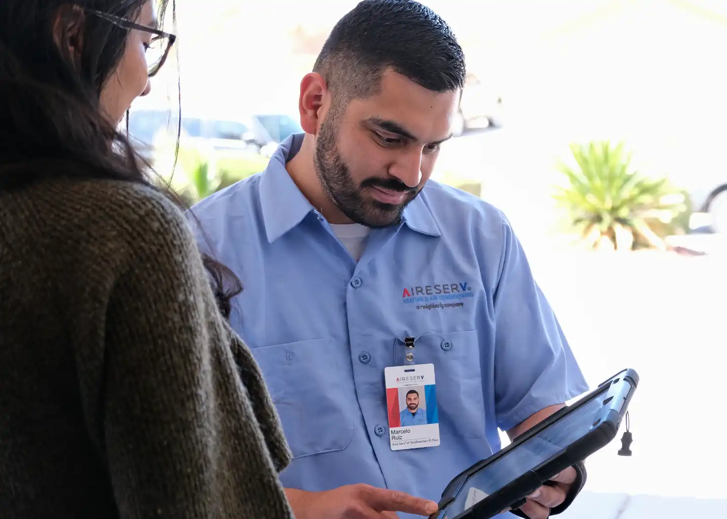 Aire Serv technician greeting a customer before an evaporative cooler repair appointment.