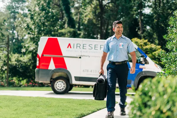 Aire Serv HVAC technician arriving for a residential service appointment.