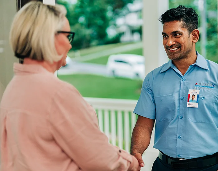 Aire Serv technician greeting a customer before a furnace repair appointment 